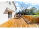 A spacious wooden deck with patio furniture offers an inviting outdoor space for relaxation and entertaining at 311 Cooks Lake Rd, Gastonia, NC 28056