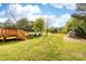 A sprawling back yard offers ample space for recreation and features mature trees and lush green grass at 311 Cooks Lake Rd, Gastonia, NC 28056