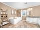 Bright bathroom features a soaking tub, decorative shelving, and stylish fixtures at 311 Cooks Lake Rd, Gastonia, NC 28056