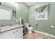 Cozy bathroom featuring a granite vanity, decorative shelving, and neutral accents at 311 Cooks Lake Rd, Gastonia, NC 28056