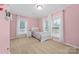 Childs bedroom featuring pink walls, two windows, and a decorative shelf at 311 Cooks Lake Rd, Gastonia, NC 28056