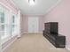 Bright bedroom featuring large windows, neutral carpet, and a built in dresser at 311 Cooks Lake Rd, Gastonia, NC 28056