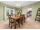 Inviting dining room features a classic table set, charming decor, and view into the kitchen at 311 Cooks Lake Rd, Gastonia, NC 28056