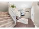 Inviting foyer with a staircase, stylish rug, and views into the living spaces at 311 Cooks Lake Rd, Gastonia, NC 28056