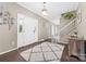 Bright foyer with hardwood floors, a white rug, and a staircase with white banisters at 311 Cooks Lake Rd, Gastonia, NC 28056