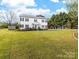 A two-story home with a large front yard, mature trees, and a long driveway at 311 Cooks Lake Rd, Gastonia, NC 28056