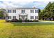 Charming two-story home with a manicured lawn, black shutters, and a welcoming front porch at 311 Cooks Lake Rd, Gastonia, NC 28056
