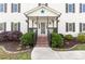 Inviting front porch with brick steps, hanging plants, string lights, and decorative star at 311 Cooks Lake Rd, Gastonia, NC 28056