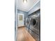 Convenient laundry room featuring modern washer and dryer units plus backyard access at 311 Cooks Lake Rd, Gastonia, NC 28056