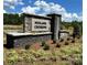 Stone entrance sign for Midland Crossing community, surrounded by well-maintained landscaping at 3244 Maya Ln # 44, Midland, NC 28107