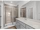 Modern bathroom with tiled shower, frameless glass and quartz vanity top at 4004 Crooked Spruce Ct, Matthews, NC 28105