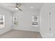 Bright bedroom with neutral carpet, ceiling fan and natural light from the large windows at 4004 Crooked Spruce Ct, Matthews, NC 28105