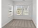 Small bedroom with neutral carpet and natural light from the large windows at 4004 Crooked Spruce Ct, Matthews, NC 28105