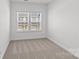 Cozy bedroom featuring neutral carpet and natural light from the windows at 4004 Crooked Spruce Ct, Matthews, NC 28105