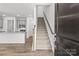 Welcoming entryway featuring a staircase, wood-look flooring, and an open view to the kitchen at 4004 Crooked Spruce Ct, Matthews, NC 28105