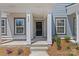 Inviting front porch with a black front door, white columns and the house number prominently displayed at 4004 Crooked Spruce Ct, Matthews, NC 28105