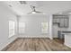 Bright and airy living room with wood-look floors, lots of windows and an adjacent kitchen area at 4004 Crooked Spruce Ct, Matthews, NC 28105