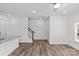 Open-concept living space with wood-look floors, a staircase, and a view into the kitchen at 4004 Crooked Spruce Ct, Matthews, NC 28105