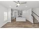 Bright, open-concept kitchen and living area with sleek gray cabinets and wood-look floors at 4004 Crooked Spruce Ct, Matthews, NC 28105