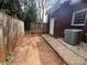 View of the backyard with wooden fence, partial brick wall, A/C unit and a small walkway at 405 N Wilson St # 101, Rock Hill, SC 29730
