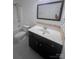 Modern bathroom features a dark vanity cabinet with a white countertop, sink, mirror, toilet, and shower at 405 N Wilson St # 101, Rock Hill, SC 29730