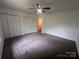 Spacious bedroom with plush carpet, ceiling fan, and ample closet space at 405 N Wilson St # 101, Rock Hill, SC 29730