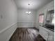 Charming dining area with dark wood flooring, classic chandelier, and convenient access to kitchen and backyard at 405 N Wilson St # 101, Rock Hill, SC 29730