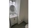 Well-lit half bathroom features a modern vanity with a round mirror and tiled backsplash at 405 N Wilson St # 101, Rock Hill, SC 29730