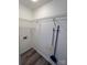 Functional laundry room equipped with wire shelving and space-saving broom and mop holders for organization at 405 N Wilson St # 101, Rock Hill, SC 29730
