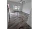 Spacious living room featuring new gray flooring, fresh paint, and ample natural light at 405 N Wilson St # 101, Rock Hill, SC 29730