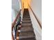Carpeted staircase with wood and iron railings leading to the upper level of the home at 405 N Wilson St # 101, Rock Hill, SC 29730