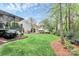 Large grassy back yard with mature trees and a covered deck at 4086 Buckingham Dr, Fort Mill, SC 29707