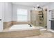 Bright bathroom with a tiled soaker tub and a glass enclosed shower at 4086 Buckingham Dr, Fort Mill, SC 29707