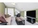 Bonus room featuring neutral carpeting, seating, built in shelving, a TV, and a ceiling fan at 4086 Buckingham Dr, Fort Mill, SC 29707