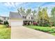 Two-story home featuring an attached garage and beautifully landscaped front yard with a long, wide driveway at 4086 Buckingham Dr, Fort Mill, SC 29707