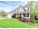 Attractive two-story home featuring a well-kept lawn and diverse landscaping with an attached two-car garage at 4086 Buckingham Dr, Fort Mill, SC 29707