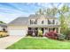 Charming two-story home with a welcoming front porch and well-manicured landscaping and an attached two-car garage at 4086 Buckingham Dr, Fort Mill, SC 29707
