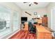 Well-lit home office with hardwood floors, built-in shelving and large windows overlooking the outside at 4086 Buckingham Dr, Fort Mill, SC 29707