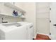 Functional laundry room with washer, dryer, and white wire shelving for ample storage at 4086 Buckingham Dr, Fort Mill, SC 29707