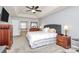 This main bedroom offers plush carpeting, a stylish upholstered headboard, and plenty of natural light at 4086 Buckingham Dr, Fort Mill, SC 29707