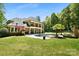 Expansive backyard features a swimming pool, spa, and outdoor kitchen and lush landscaping at 5001 Oxfordshire Rd, Waxhaw, NC 28173