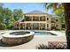 Gorgeous backyard features a pool, hot tub, and outdoor kitchen for luxury living at 5001 Oxfordshire Rd, Waxhaw, NC 28173