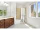 Bathroom with tile flooring, a shower with a shower curtain, dark wood cabinets, and a large vanity mirror at 5001 Oxfordshire Rd, Waxhaw, NC 28173