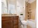 Bathroom with tile shower, wood cabinet and granite vanity, and a decorative plant on the toilet's tank at 5001 Oxfordshire Rd, Waxhaw, NC 28173
