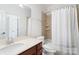 Well-lit bathroom features a shower with beige tile and a vanity with neutral countertops at 5001 Oxfordshire Rd, Waxhaw, NC 28173
