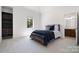 Bedroom featuring carpet, a dark wood bed, a single window, a bookcase, and a bathroom entrance at 5001 Oxfordshire Rd, Waxhaw, NC 28173