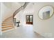 Bright foyer with a curved staircase, tile flooring, and decorative front door at 5001 Oxfordshire Rd, Waxhaw, NC 28173