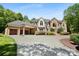 Brick home featuring a basketball hoop over the driveway and a beautifully landscaped front yard at 5001 Oxfordshire Rd, Waxhaw, NC 28173