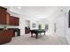 Game room with a pool table, carpet, several windows, and a kitchenette along the wall at 5001 Oxfordshire Rd, Waxhaw, NC 28173