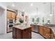 A kitchen with light wood cabinets, stainless steel appliances, and an island with granite countertops at 5001 Oxfordshire Rd, Waxhaw, NC 28173